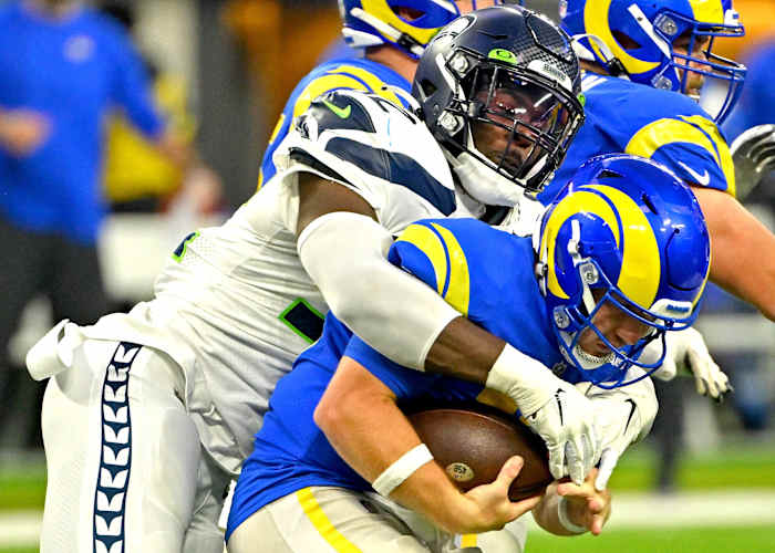 Los Angeles Rams quarterback John Wolford (13) is sacked by Seattle Seahawks defensive end Darrell Taylor (52) in the fourth quarter at SoFi Stadium.
